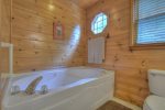 Master bathroom offers a large shower stall and jetted garden tub 